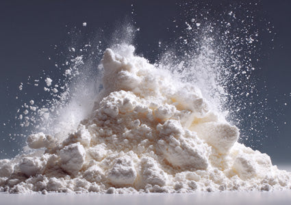 ALPHA GPC photo. White powdery substance being thrown into the air against a dark background