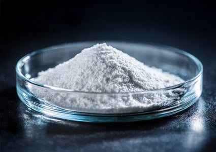 L-Isoleucine white powder in a glass dish on a dark background