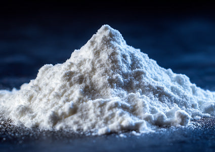 L-Tyrosine represented as a white powdery substance on a dark background