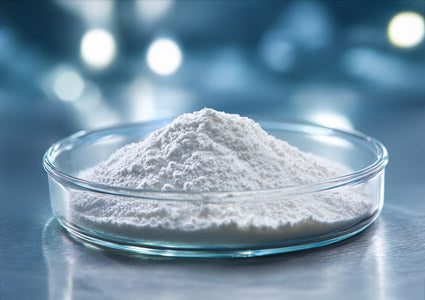 L-Valine White powder in a glass dish on a reflective surface with blurred lights in the background